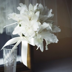 純白の花をふんわりと束ねた華美になりすぎないブーケでドレス姿を清楚に彩って