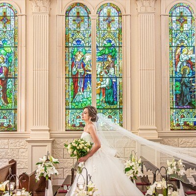 バージンロードを歩む花嫁の背後にもステンドグラスが。絵画のような写真が残せる！